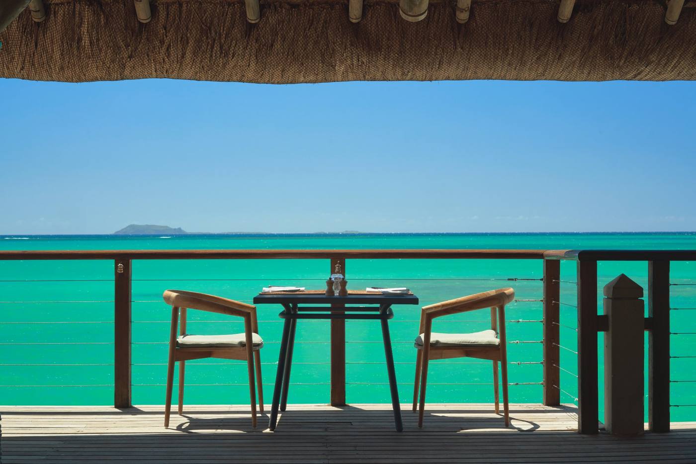Table dressée pour deux sur la terrasse du Peninsula, face à la mer